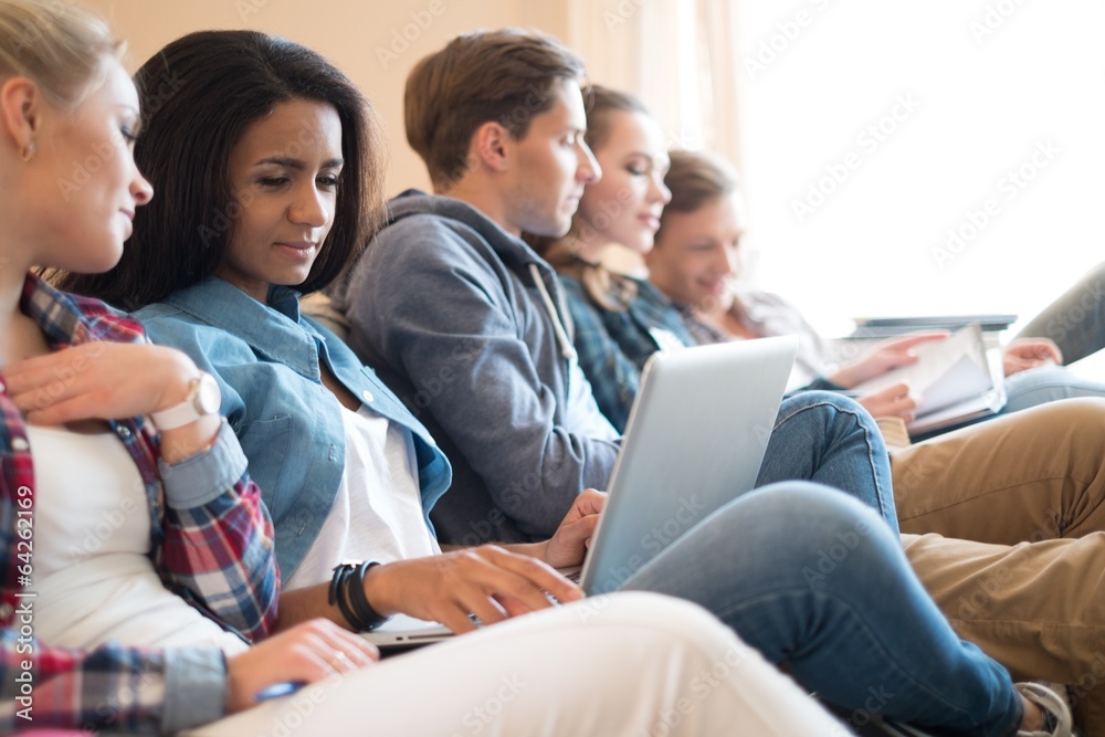 Group of students preparing for exams in apartment interior Group of students preparing for exams in apartment interior