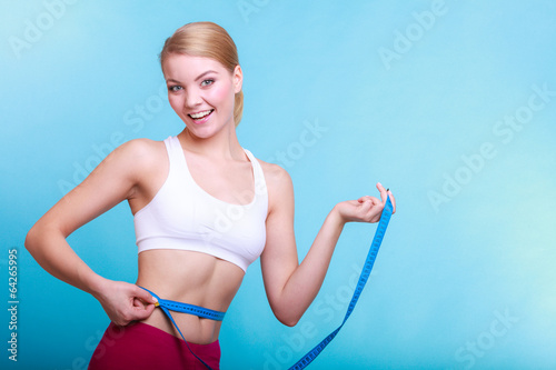 Diet. Woman fit girl with measure tape measuring her waist © Voyagerix