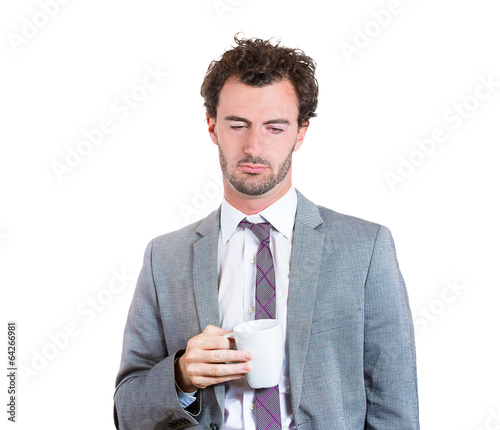 Photography Sleepy business man after long working hours holds cup coffee
