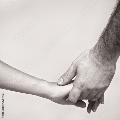 monotone shot of couple holding hands