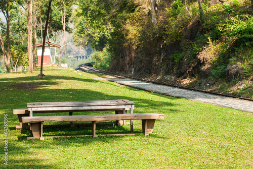 Old wood bench in the park near railway track