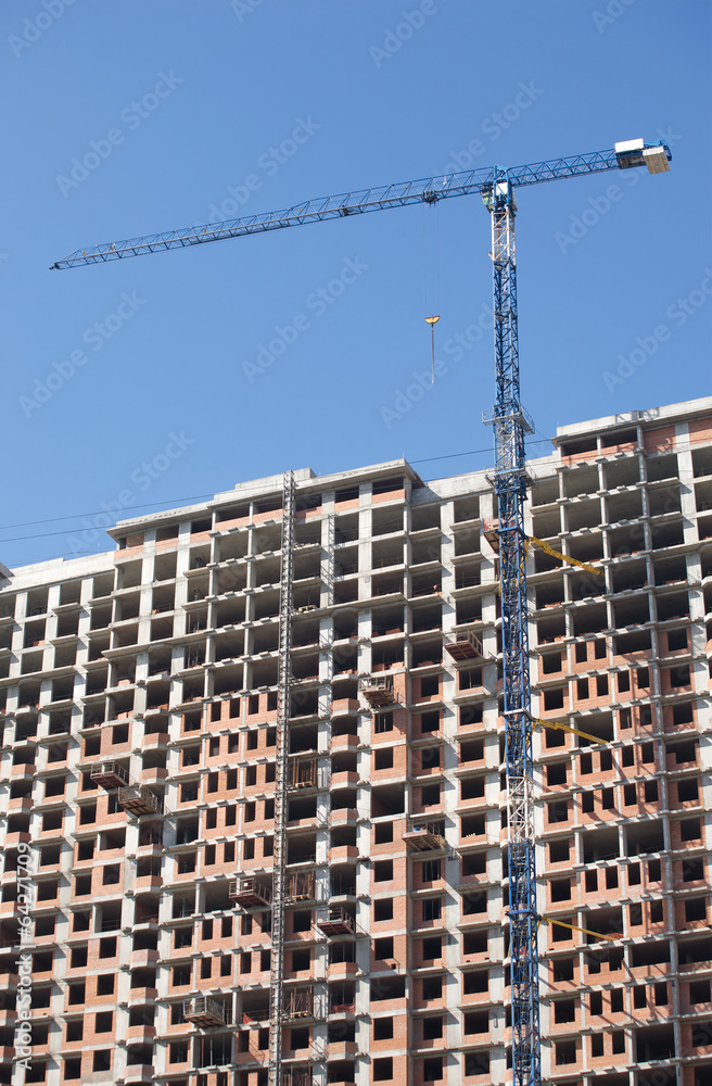 Long tower crane and top of construction building Long tower crane and top of construction building