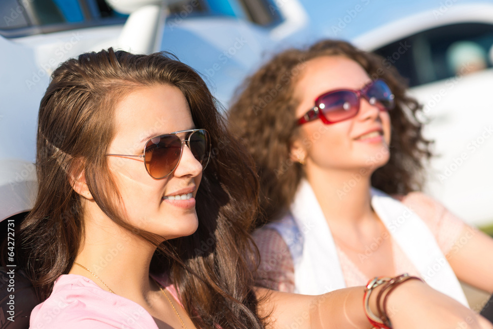 Two attractive young women wearing sunglasses Two attractive young women wearing sunglasses