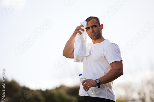 Man refreshing after running