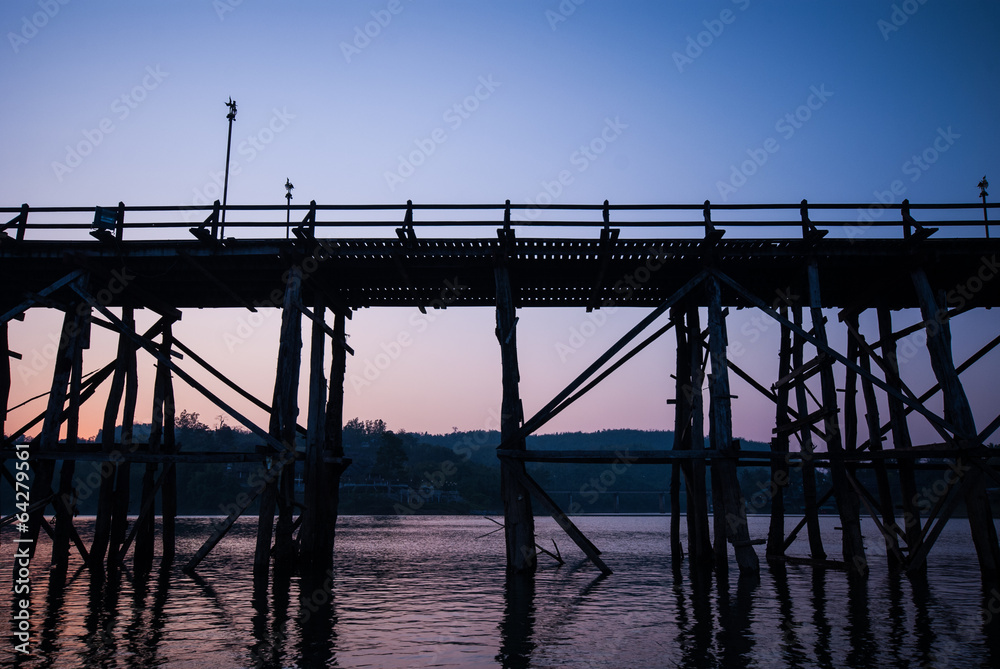Sunset at the longest wooden bridge and floating Town in Sangkla