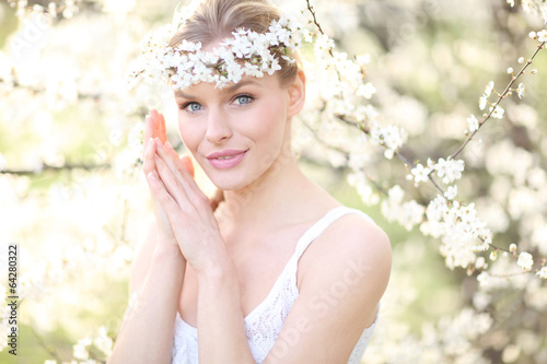 Beautiful spring blonde girl with flowers