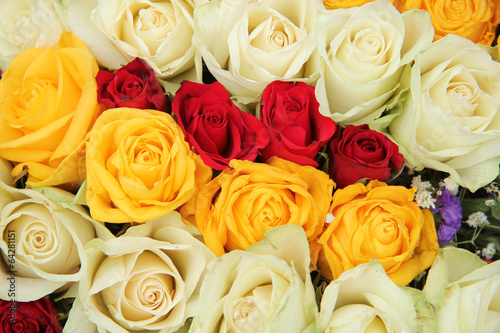 Yellow, white and red roses in a wedding arrangement