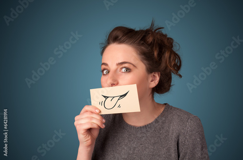 Pretty young girl holding white card with smile drawing