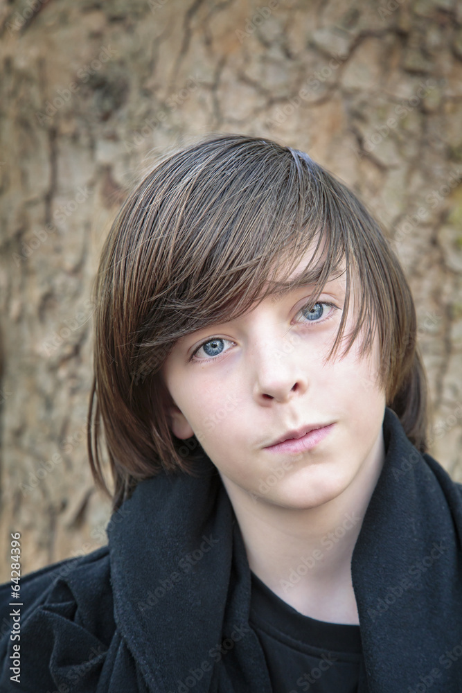 outdoor portrait of a male teenager in front of a tree
