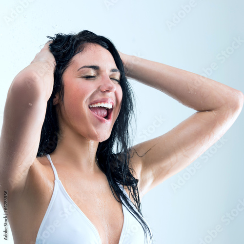 Woman showering with happy smile and water splashing