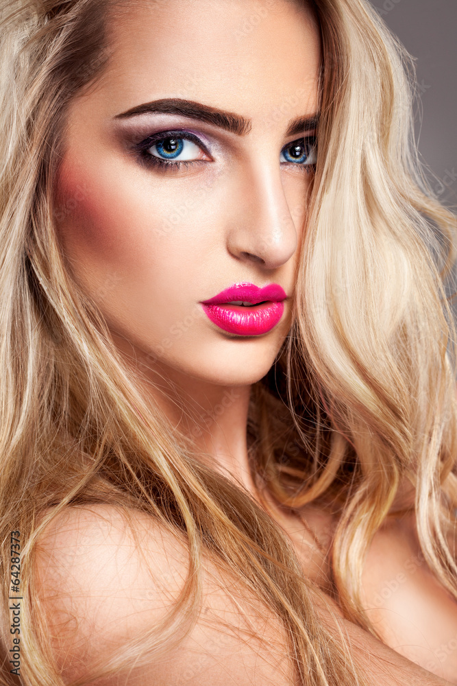Sexy blonde woman with makeup and blue eyes looking at camera Stock Photo |  Adobe Stock