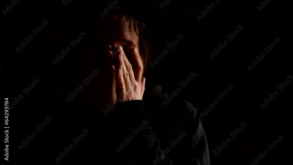 Sad man covering face with hands and crying in despair. Sad man covering face with hands and crying in despair.