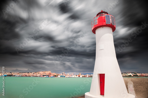 Red lighthouse in the enter of the harbor