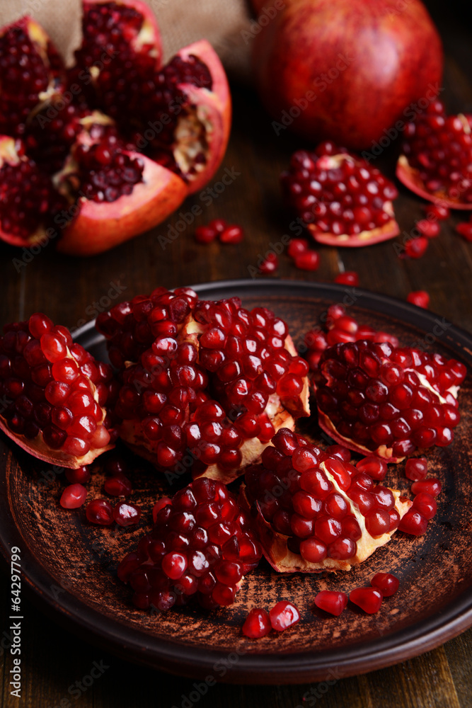 Ripe pomegranates on table close-up Ripe pomegranates on table close-up