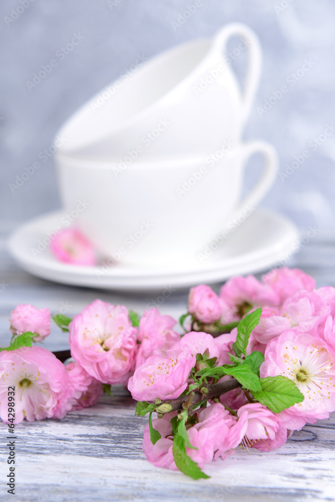 Beautiful fruit blossom in glass on table on grey background Beautiful fruit blossom in glass on table on grey background