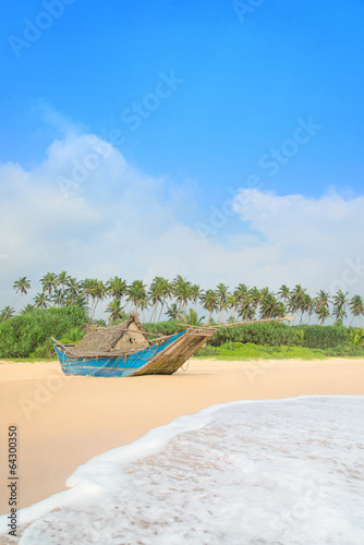Fishing boat at beautiful ocean palm beach