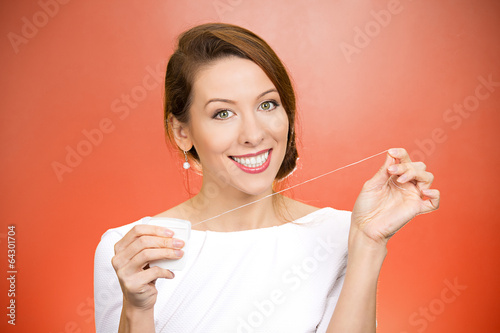 Fototapeta Naklejka Na Ścianę i Meble -  Female doctor dentist suggesting to floss daily