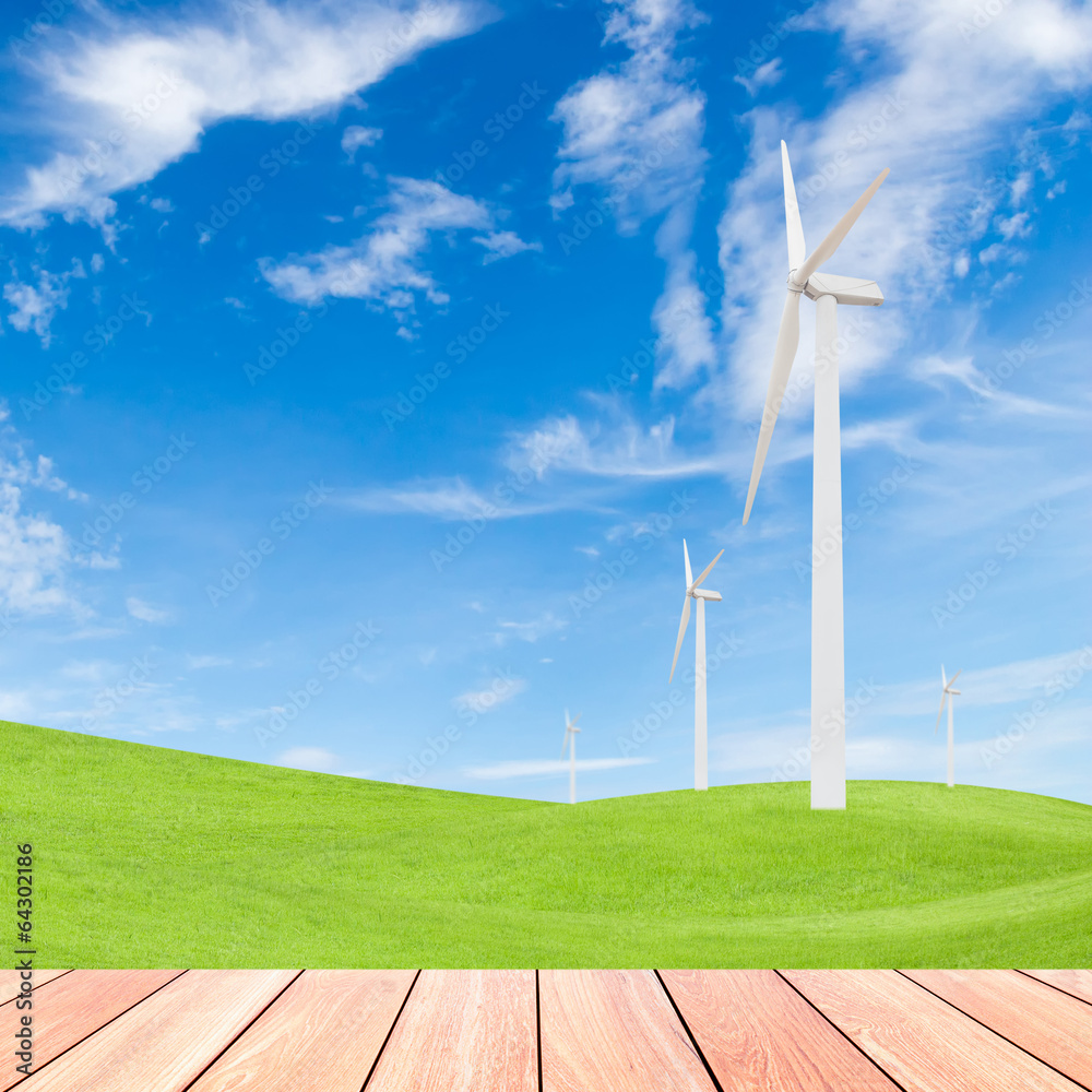 Obraz premium wind turbine on green grass field and blue sky background