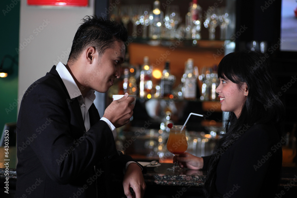 Photograph of couple relaxing at bar or lounge