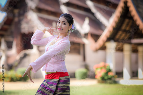 Thai dancing girl with northern style dress in temple