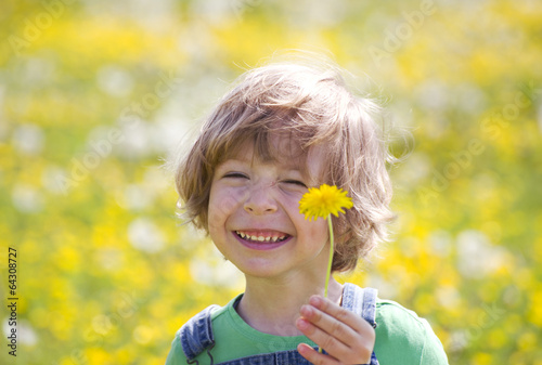 Kind mit L  wenzahn auf einer gelben Wiese