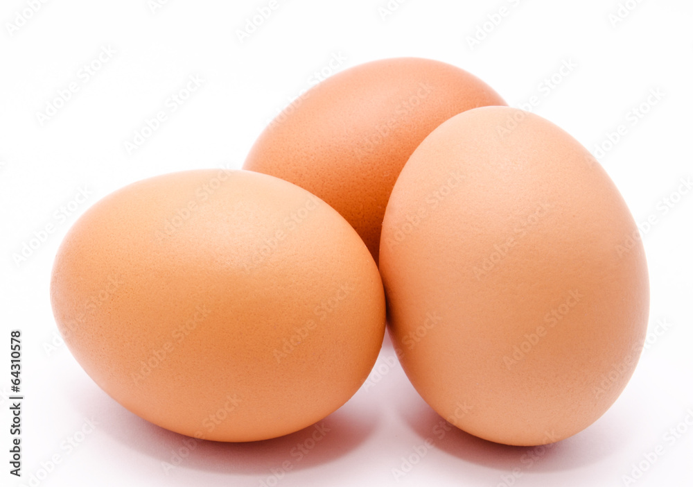 Three brown chicken eggs isolated on a white background Three brown chicken eggs isolated on a white background