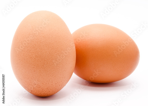 Two brown chicken eggs isolated on a white background