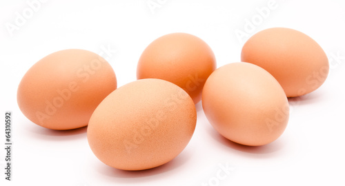 Five brown chicken eggs isolated on a white background
