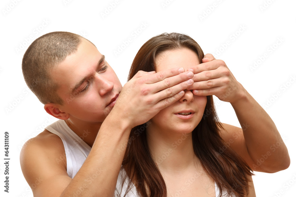 Young beautiful loving couple is embracing - on white background Young beautiful loving couple is embracing - on white background