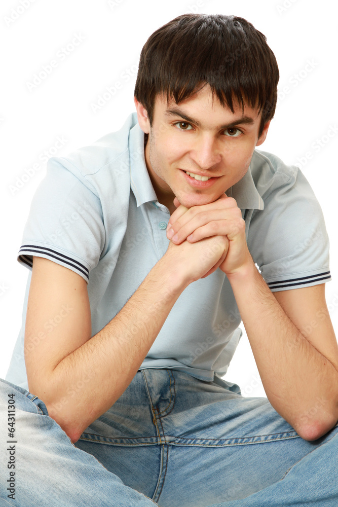 A college boy sitting isolated on white background. A college boy sitting isolated on white background.