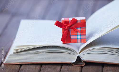 Gift box on opened book.