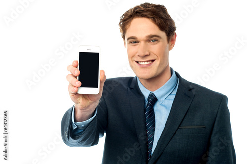 Salesman displaying newly launched mobile