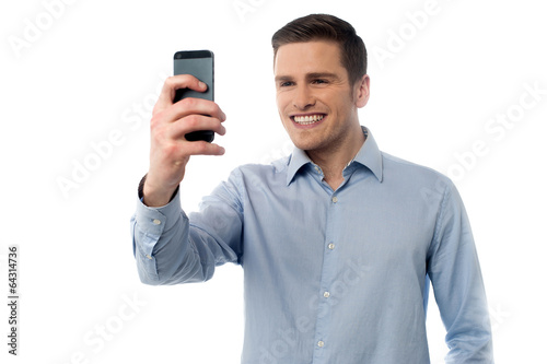 Young man browsing in mobile phone © stockyimages