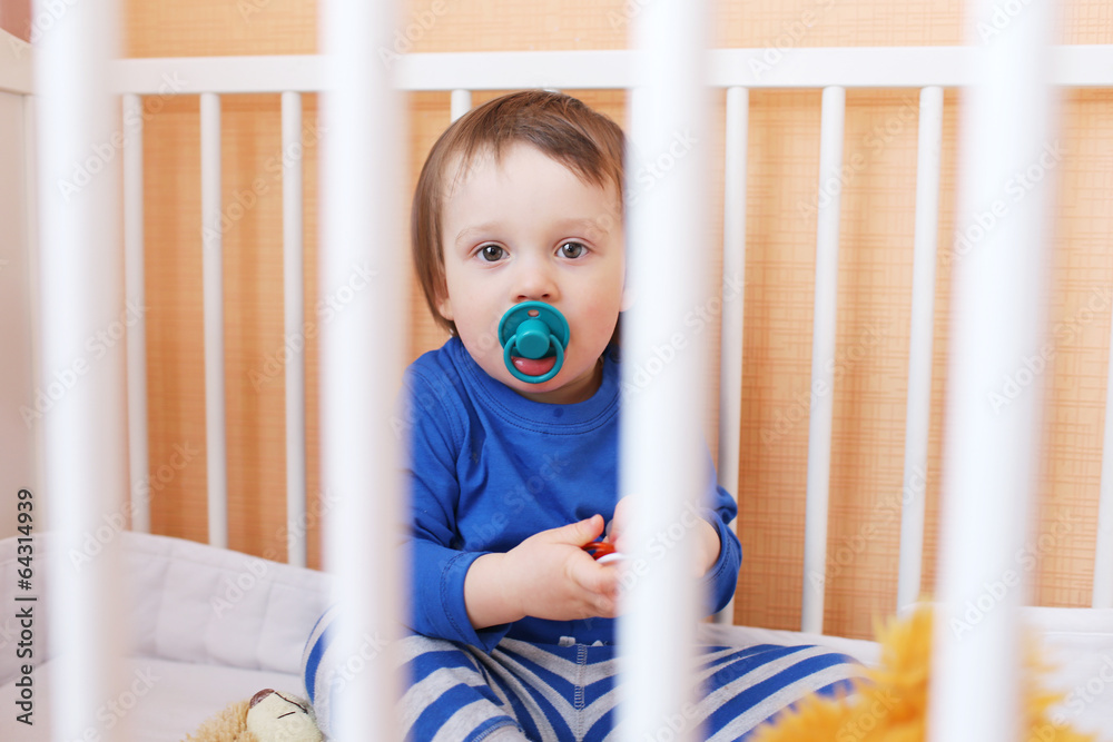 baby with pacifier in white bed baby with pacifier in white bed