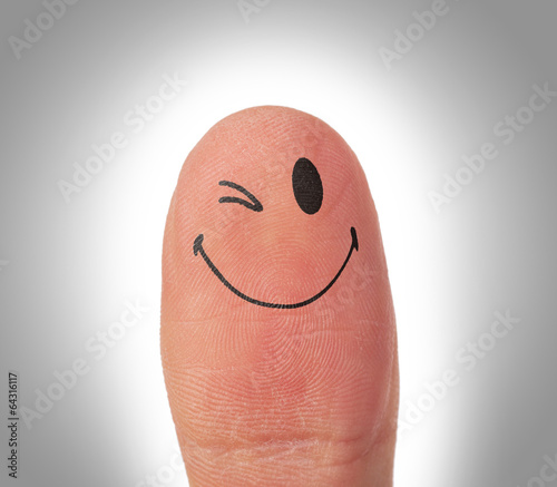 Female thumbs with smile face on the finger photo