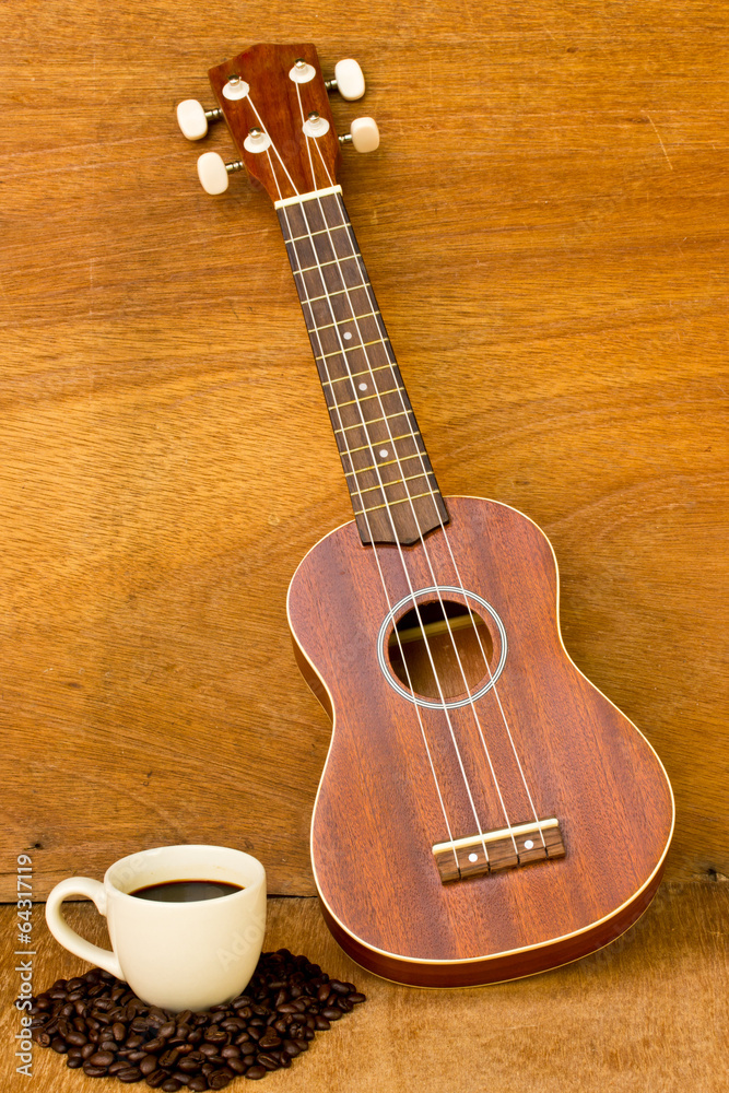 Coffee and Ukulele on wood background Coffee and Ukulele on wood background