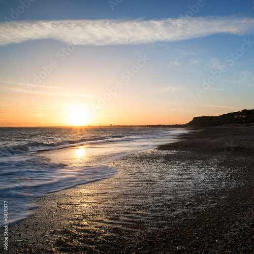 Stunning sunset over beach long exposure landscape