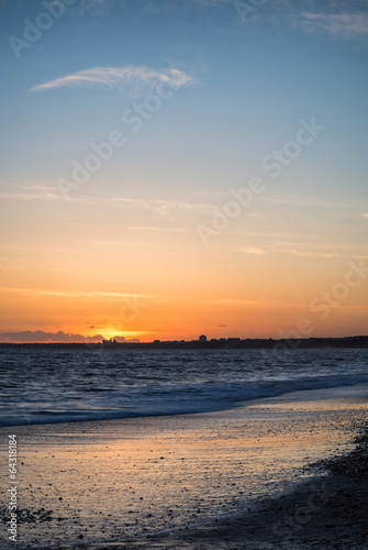 Stunning sunset over beach long exposure landscape