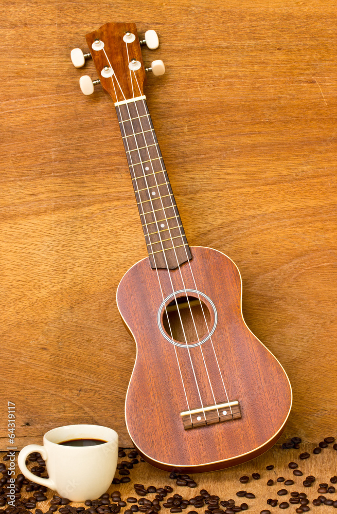 Obraz premium Coffee and Ukulele on wood background