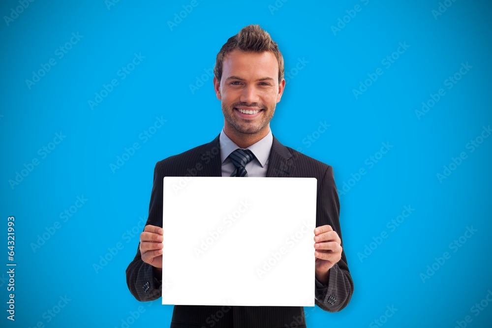 Composite image of businessman showing card