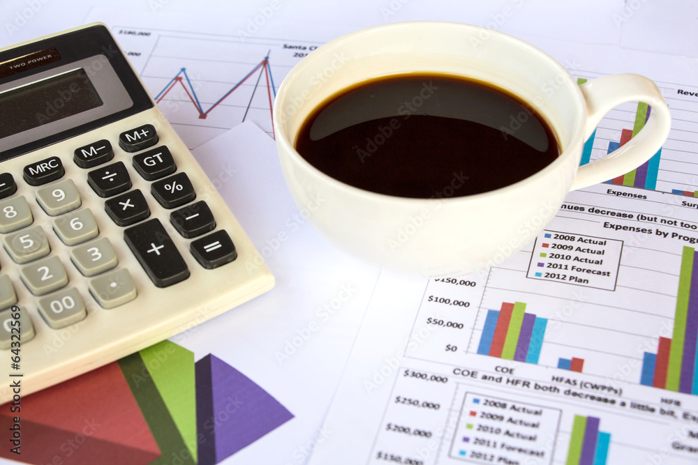 Business papers with charts and graphs and with a cup of coffee. Business papers with charts and graphs and with a cup of coffee.