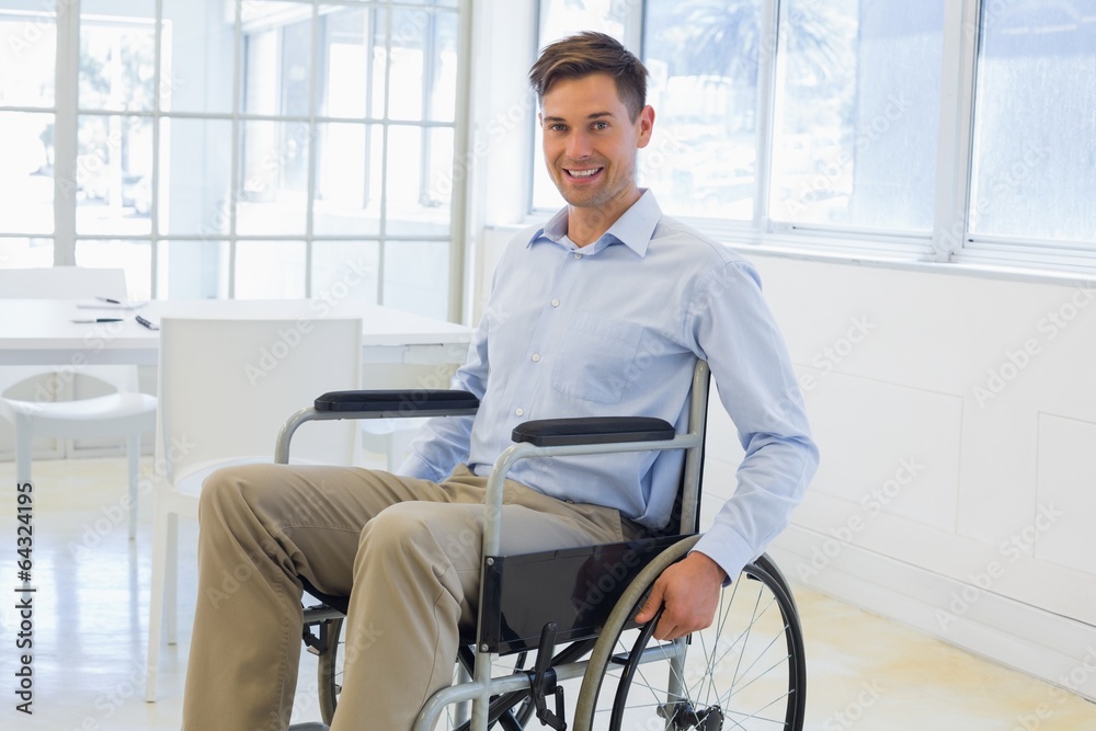 Casual businessman in wheelchair smiling at camera Casual businessman in wheelchair smiling at camera