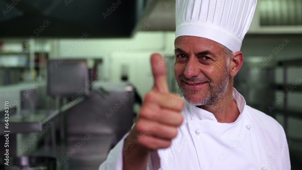 Head chef giving thumbs up and smiling at camera Head chef giving thumbs up and smiling at camera