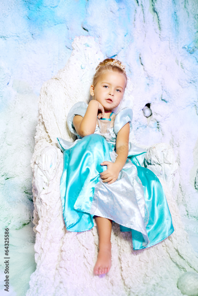 Little girl in princess dress on a background of a winter fairy