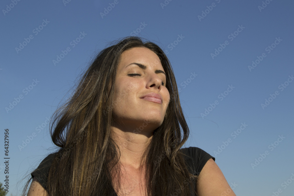 Satisfied woman in the evening sun - meditation Satisfied woman in the evening sun - meditation