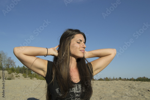 Satisfied woman in the evening sun - meditation