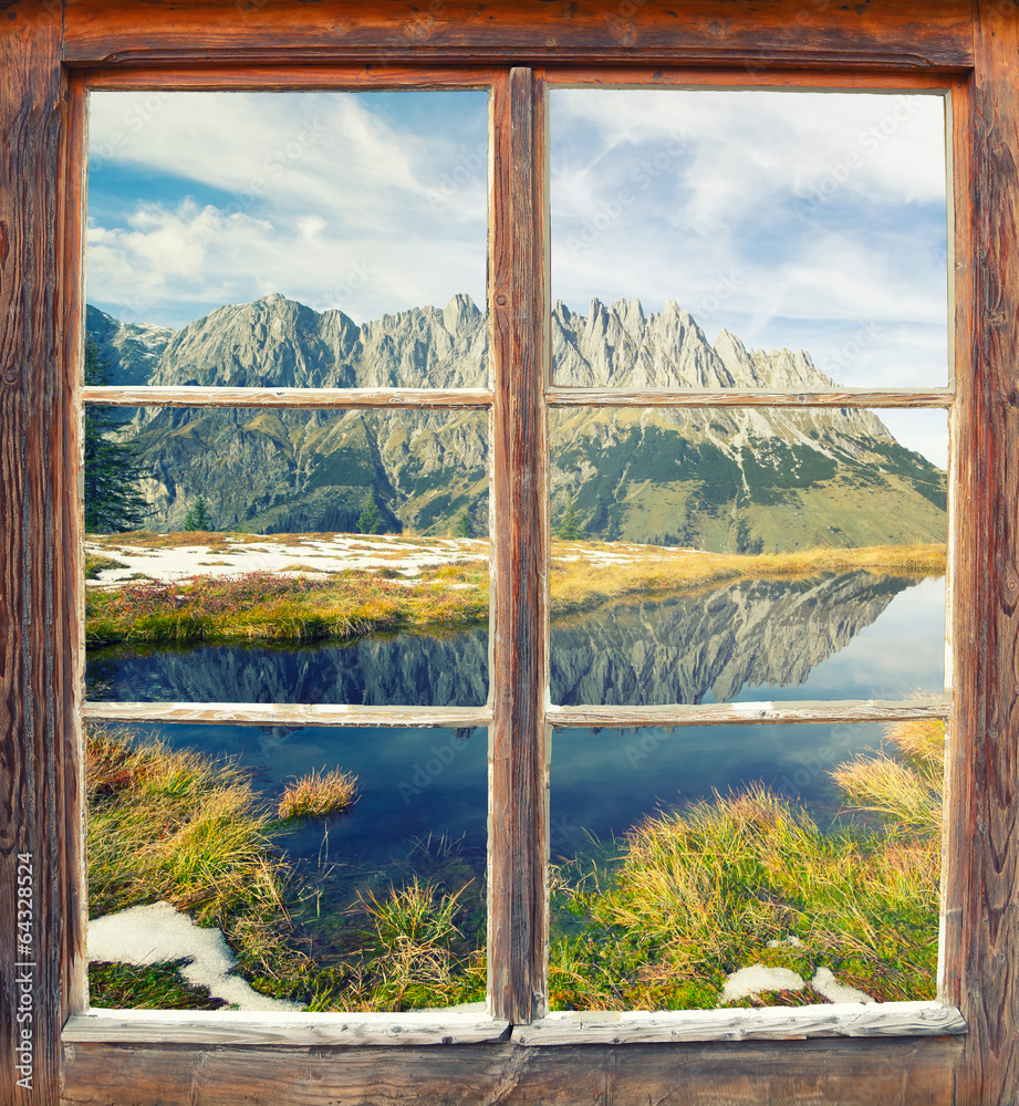 Fototapeta Zamknięte stare, drewniane okno z widokiem na góry, rzekę i polanę