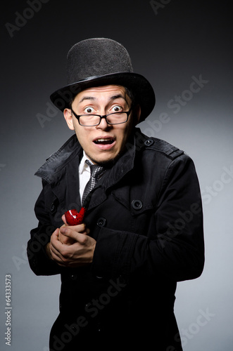 Funny detective with pipe and hat