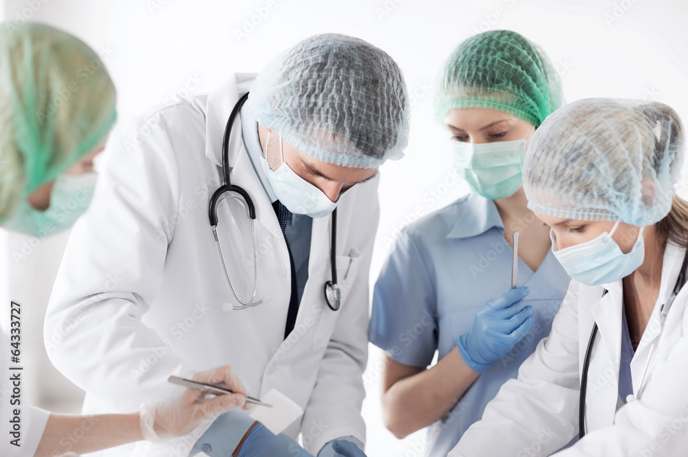 young group of doctors doing operation young group of doctors doing operation