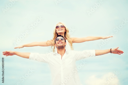 couple holding hands up at sea side